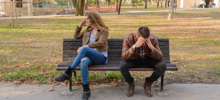 Couple sitting on a bench and going through intimacy issues.