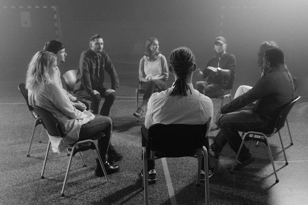 Group of people talking about the principles of the 12 steps.