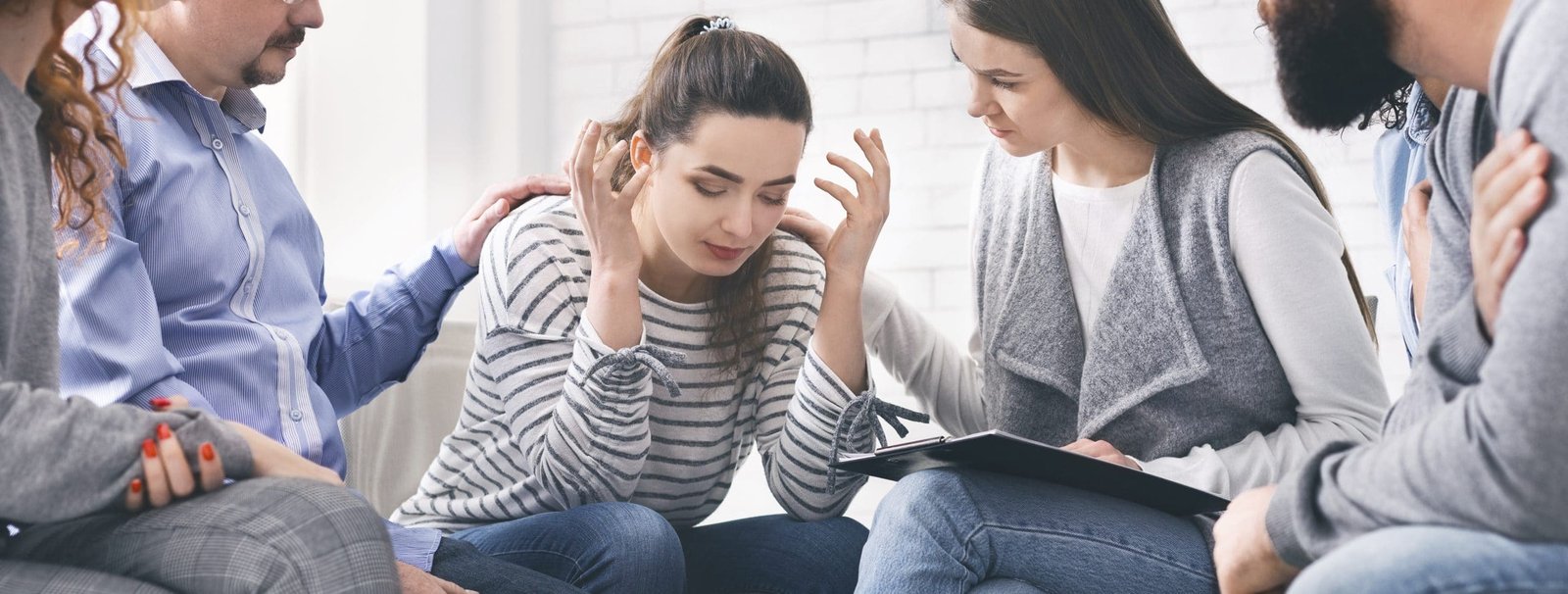 a group of people sitting together and talking to a woman suffering from alcohol abuse representing living with an alcoholic