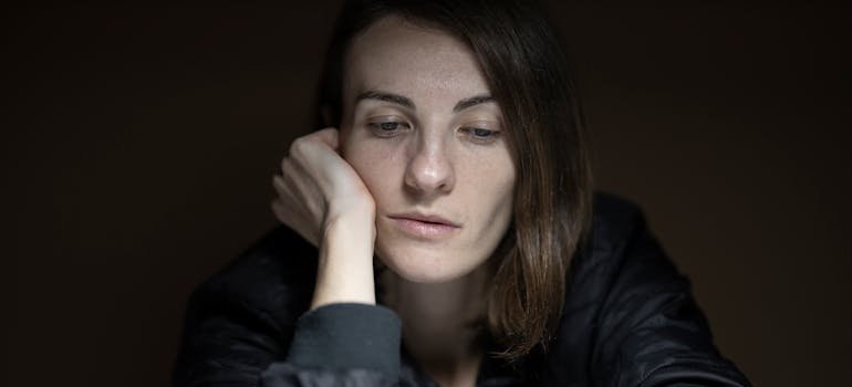 Depressed woman thinking about using essential oils for depression.