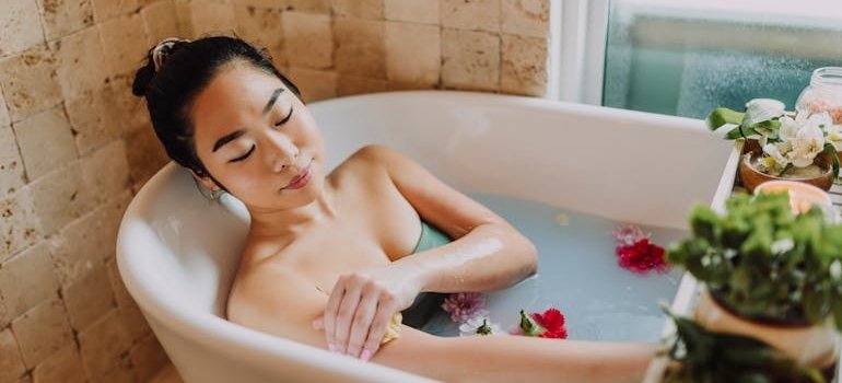 Woman using depression oils for depression in a bath.