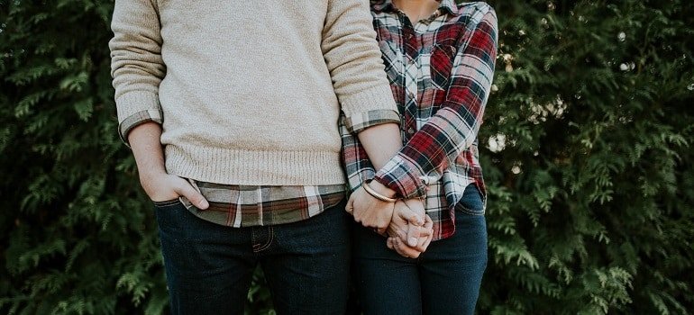 Happy couple holding hands.