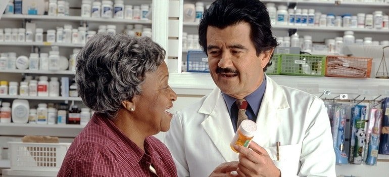 Doctor giving woman prescription medication.