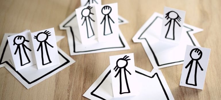 A paper representation of people in different houses. 