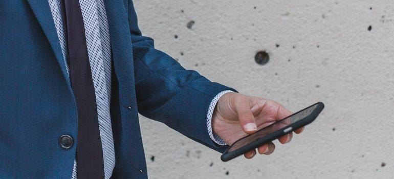 A man holding a phone, getting ready to call the best rehab center Reading PA.