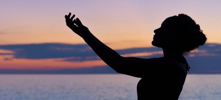 A woman posing during sunset.