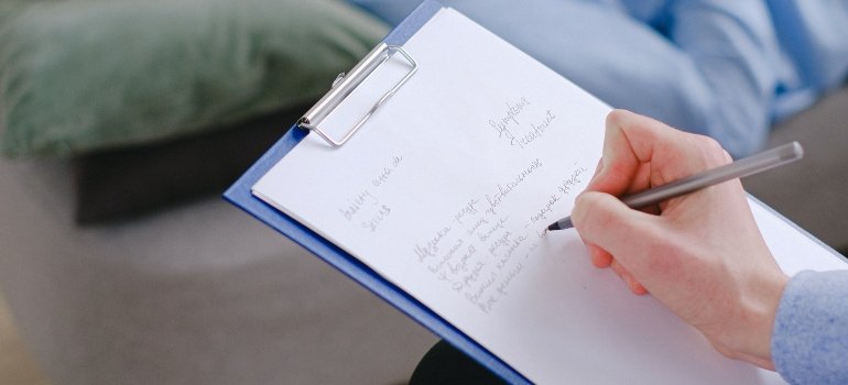 person writing down something