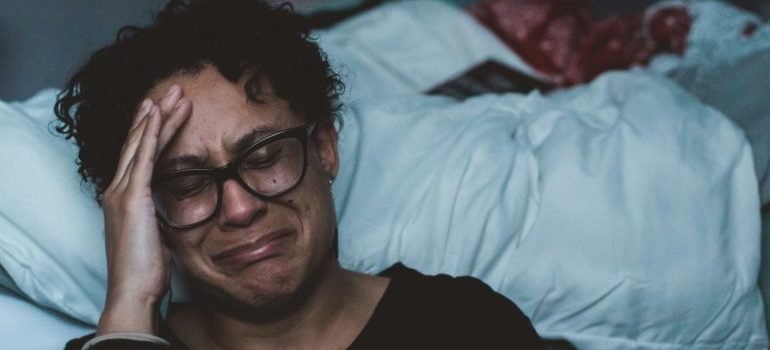 A person crying on the floor.