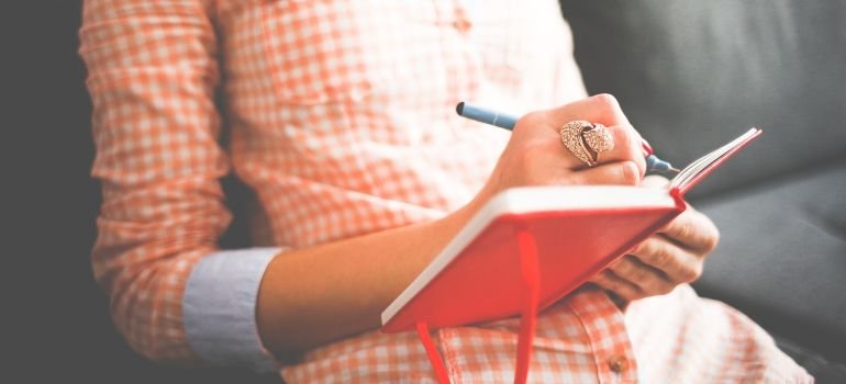 A woman writing in a journal.