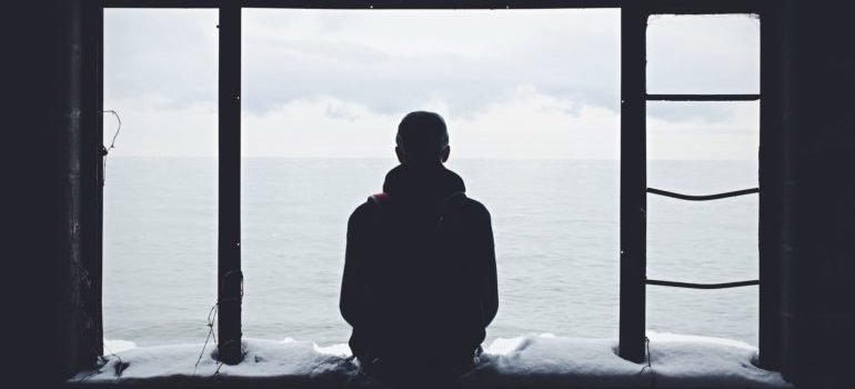 A person sitting alone by the sea.