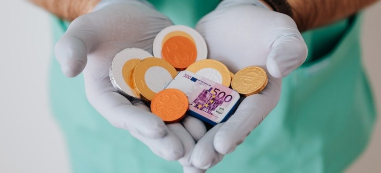 a doctor holding chocolate coins