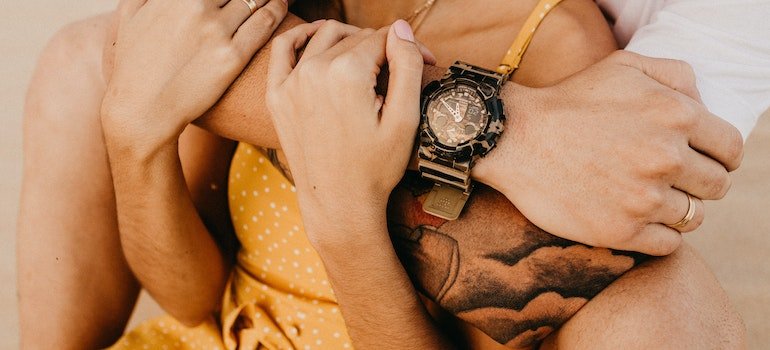 Man holding a woman from behind.