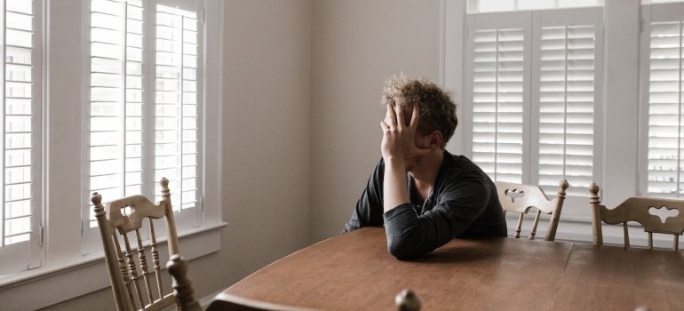 a sad man dealing with grief and loss while in recovery