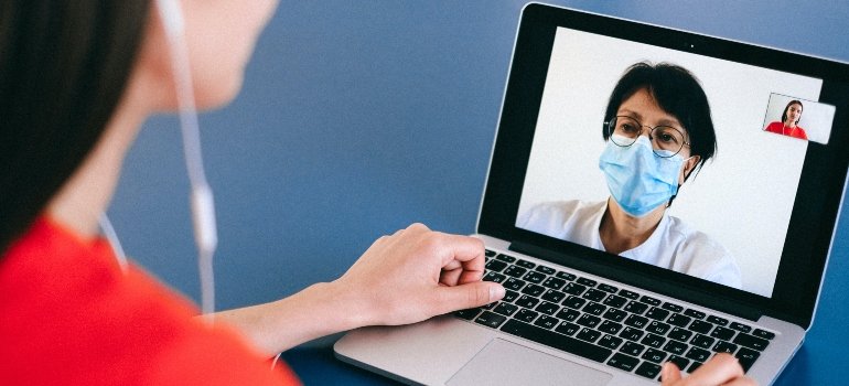 person talking to a doctor via a laptop