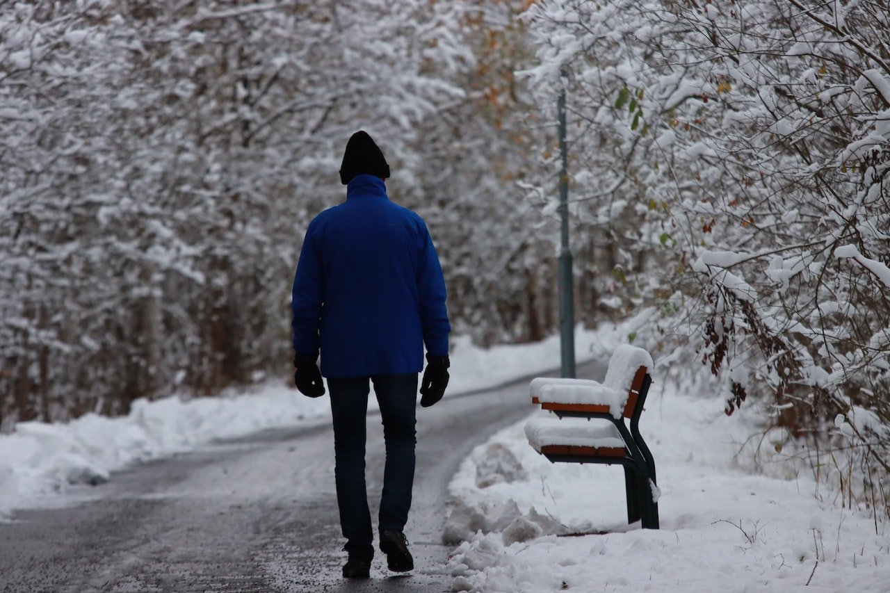 a man walking through a snowy street