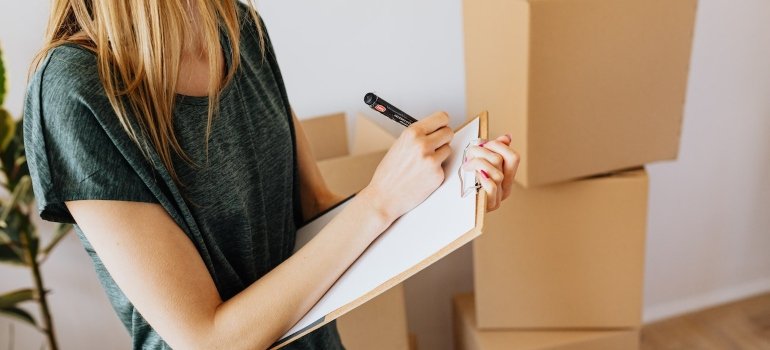 a woman writing something down while preparing for a loved one's return from PA rehab