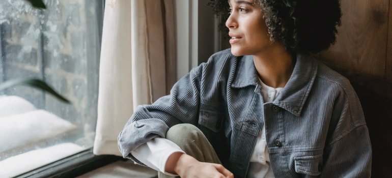 a sad woman coping with grief and loss while in recovery