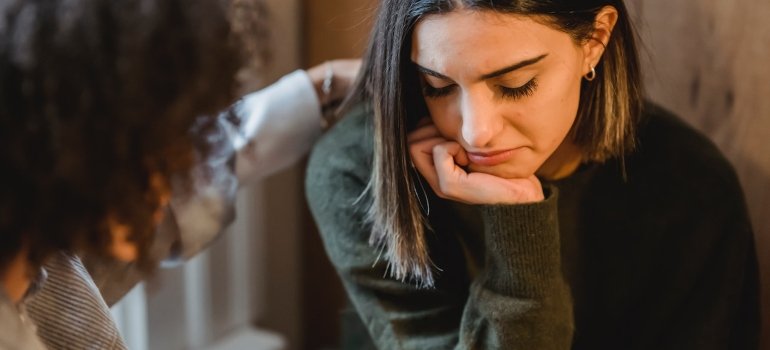 a woman comforting another woman after preparing for a loved one's return from PA rehab