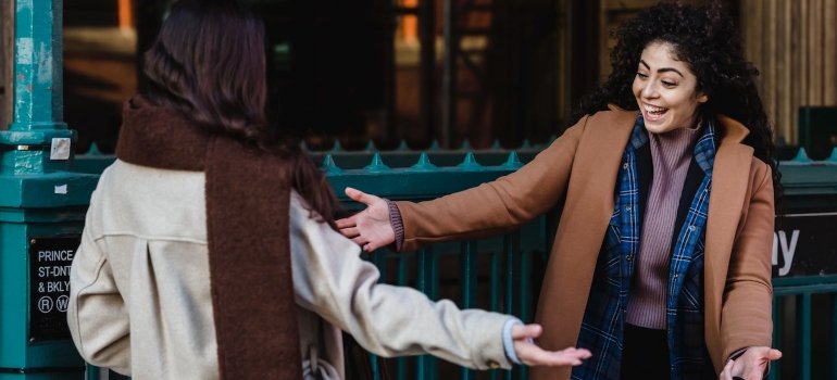 two women going in for a hug