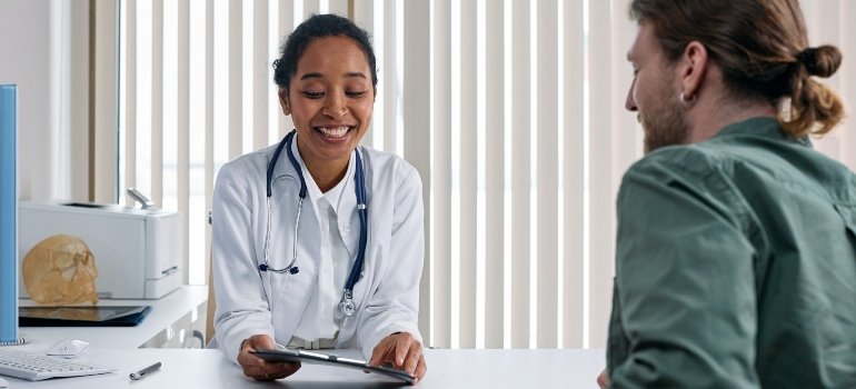 smiling doctor explaining MAT detox for drug addiction