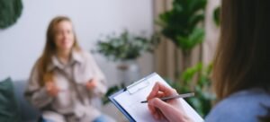 A counselor and patient sitting across from each other, engaged in a one-on-one counseling session 