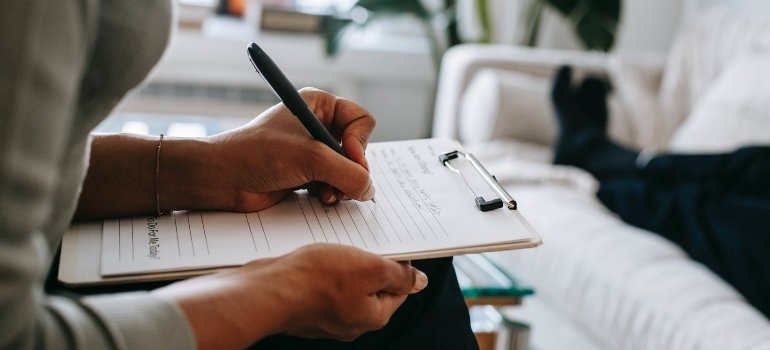 unrecognizable person writing a plan