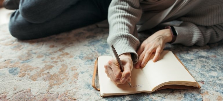 a woman journaling and deciding to take a break from dating in early recovery