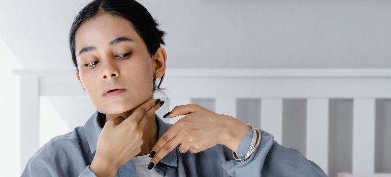 person holding their throat with their hands