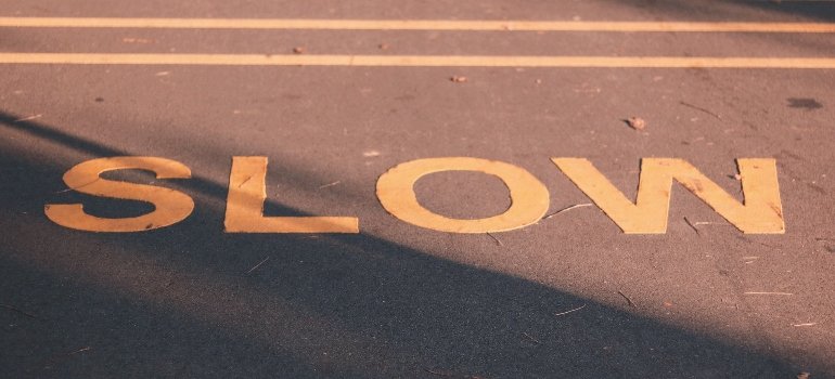 the word "slow" on concrete