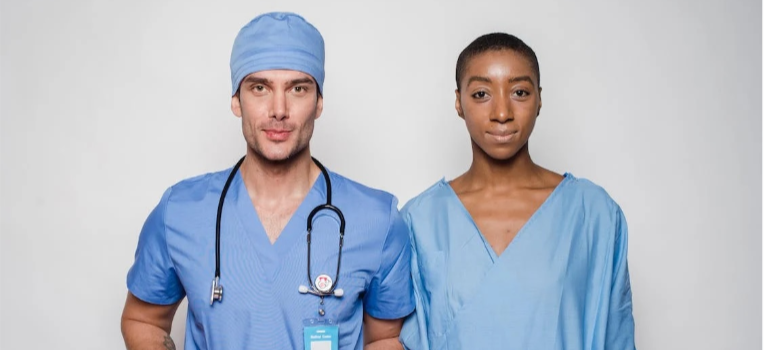 Two heroin addiction treatment providers in blue scrub suits smiling at the camera representing heroin rehab pennsylvania