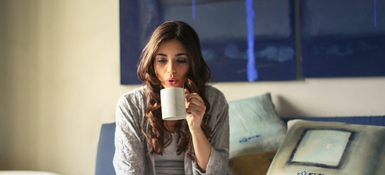 person drinking from a mug and thinking about How Long Does Heroin Detox Take