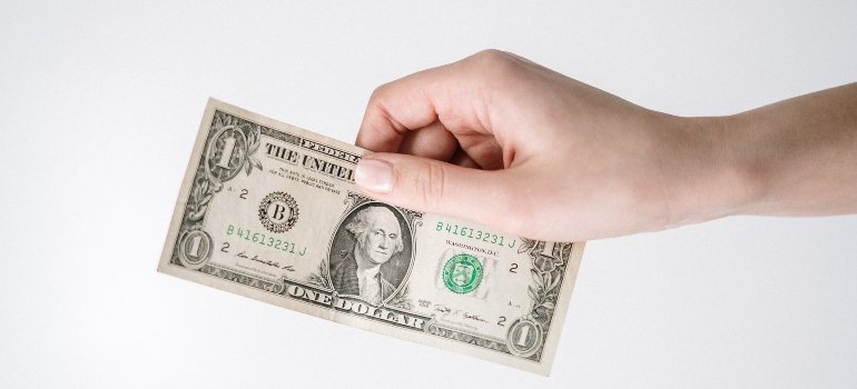 person holding a $1 bill