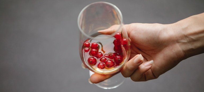 person holding a glass of alcoholic beverage