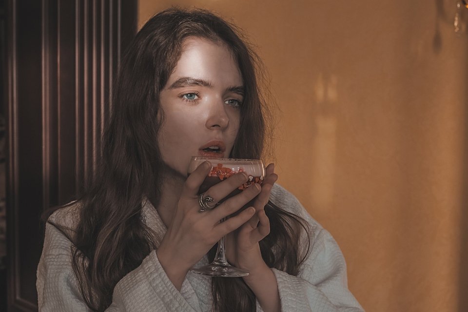 woman holding a glass and thinking about alcohol and women's health