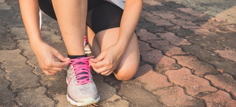 person tying their shoes