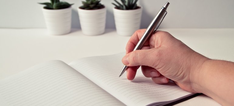 person writing a plan about managing triggers during alcohol recovery in PA