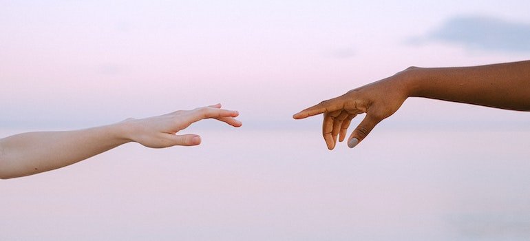 Two hands reaching for each other.