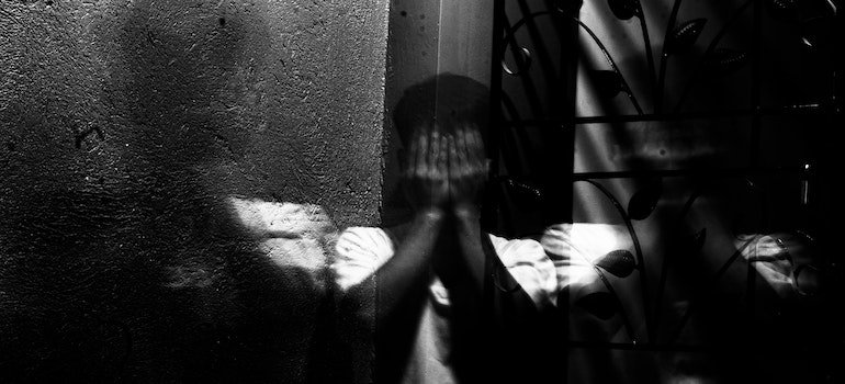 Person covering their face with their hands representing Physical Heroin Withdrawal Last