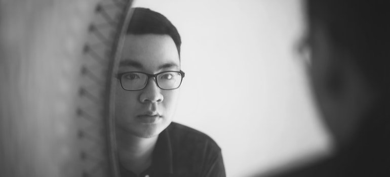 Person looking at themselves in the mirror.