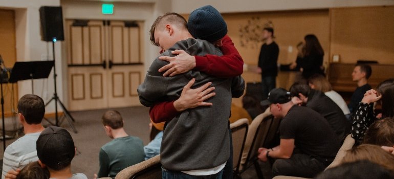 Two people hugging during support group therapy for people battling alcoholism and depression