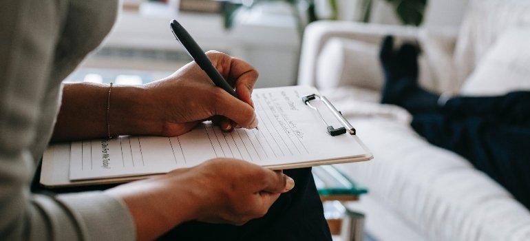 person writing about rehab away from home