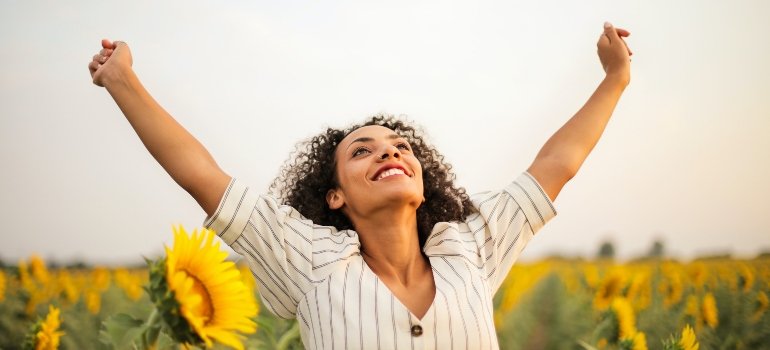 person raising their arms in success