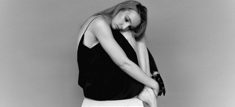 Depressed woman sitting on a chair and crying