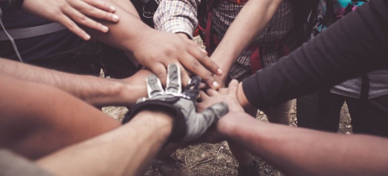 several hands joined together in support