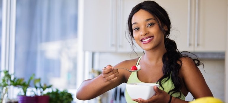 Woman eating a salad in the kitchen