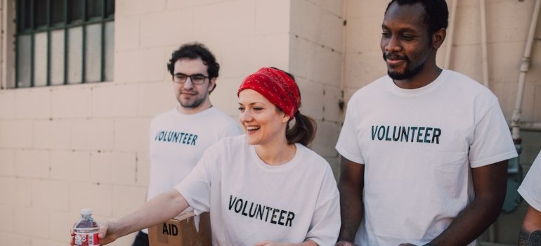 Three volunteers sharing food