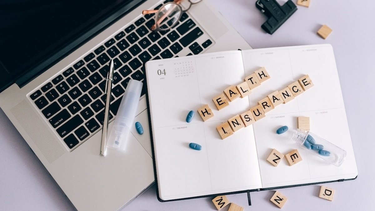 Person using laptop to explore insurance options for dual diagnosis treatment.
