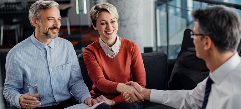 A couple and a businessman reaching an agreement in terms of Early Stages of Recovery
