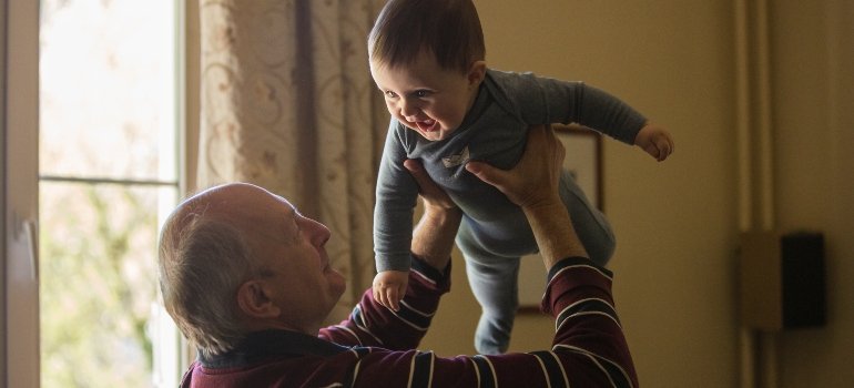 Grandpa holding his grandson.
