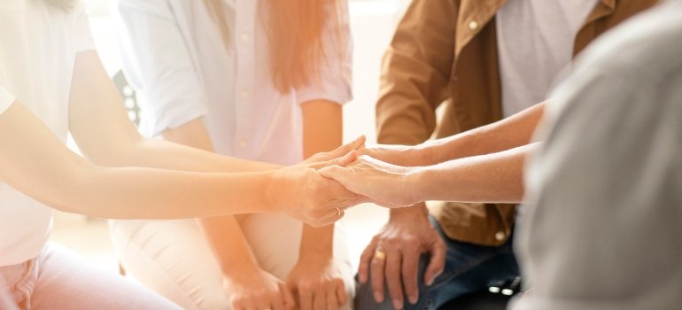 A group of people holding hands 